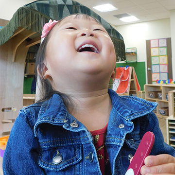 young girl laughing in classroom 